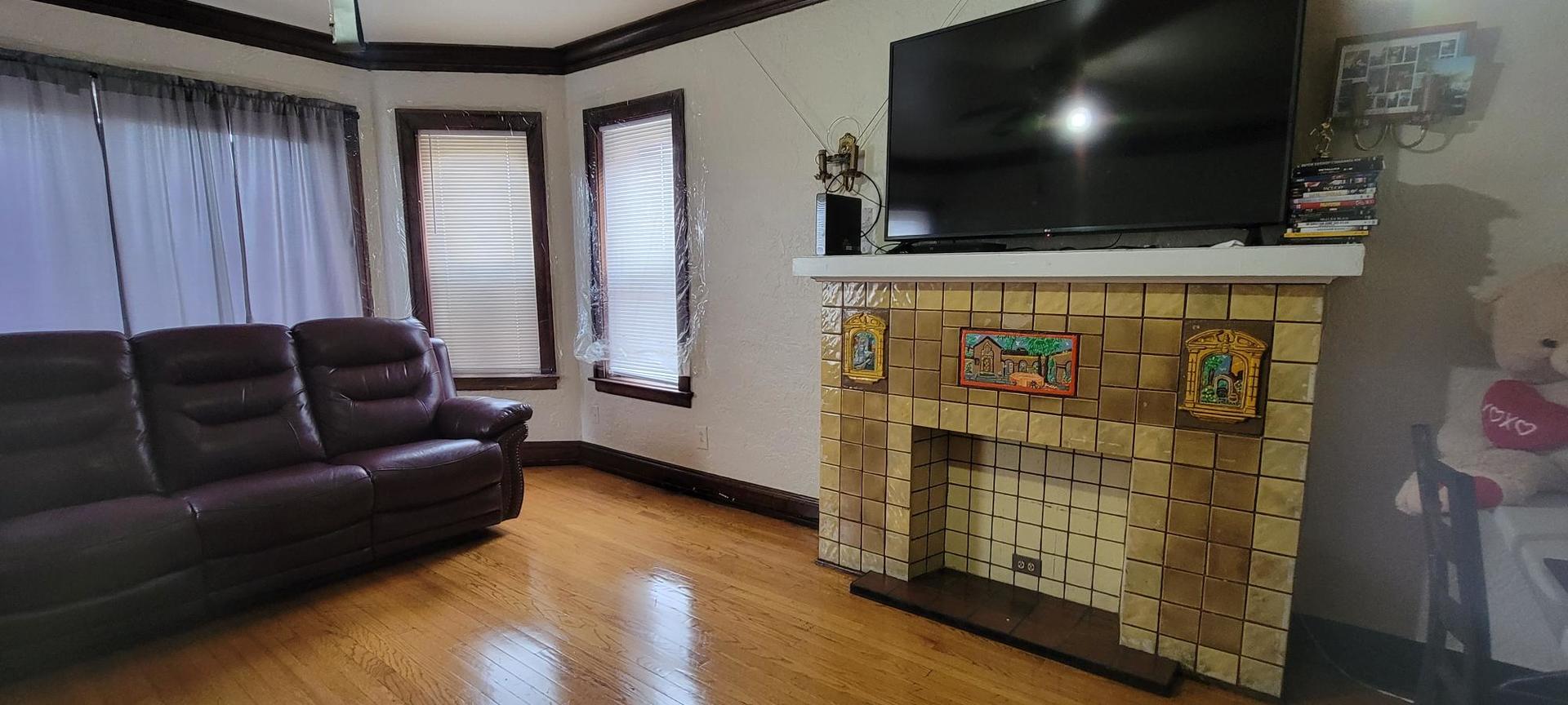 10652 South Ave B Chicago, IL 60617 - Photo 8 of 18 a living room with furniture and a flat screen tv