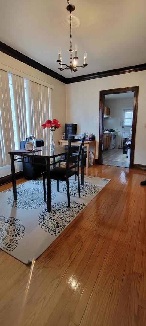 10652 South Ave B Chicago, IL 60617 - Photo 9 of 18 a view of a dining room with furniture window and wooden floor