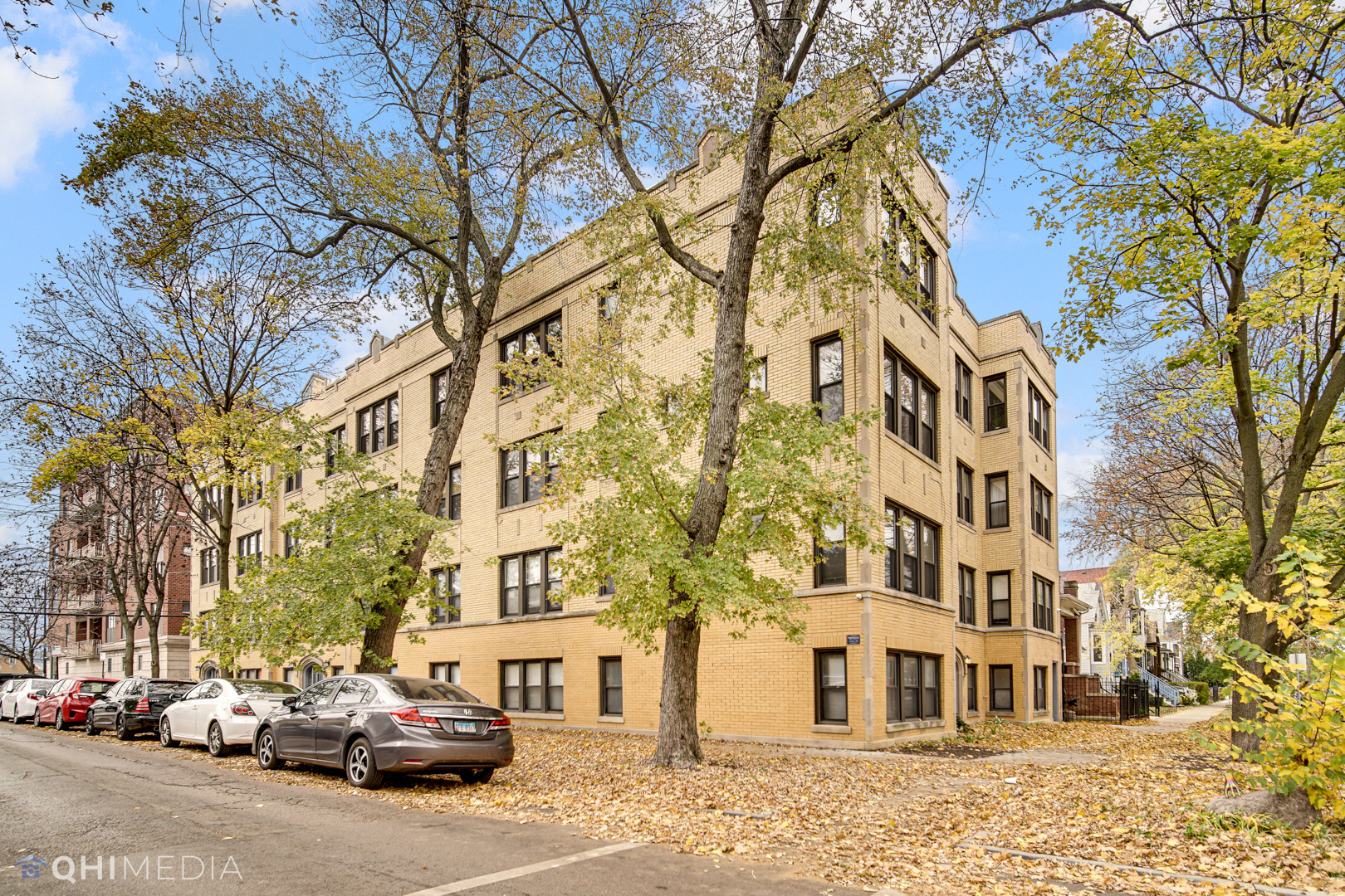 4014 North Spaulding Avenue, Unit 3 Chicago, IL 60618 - Photo 1 of 16 a city street lined with parked cars and buildings