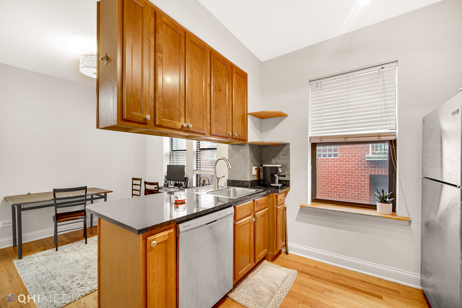 4014 North Spaulding Avenue, Unit 3 Chicago, IL 60618 - Photo 11 of 16 a kitchen with stainless steel appliances granite countertop a sink stove and refrigerator