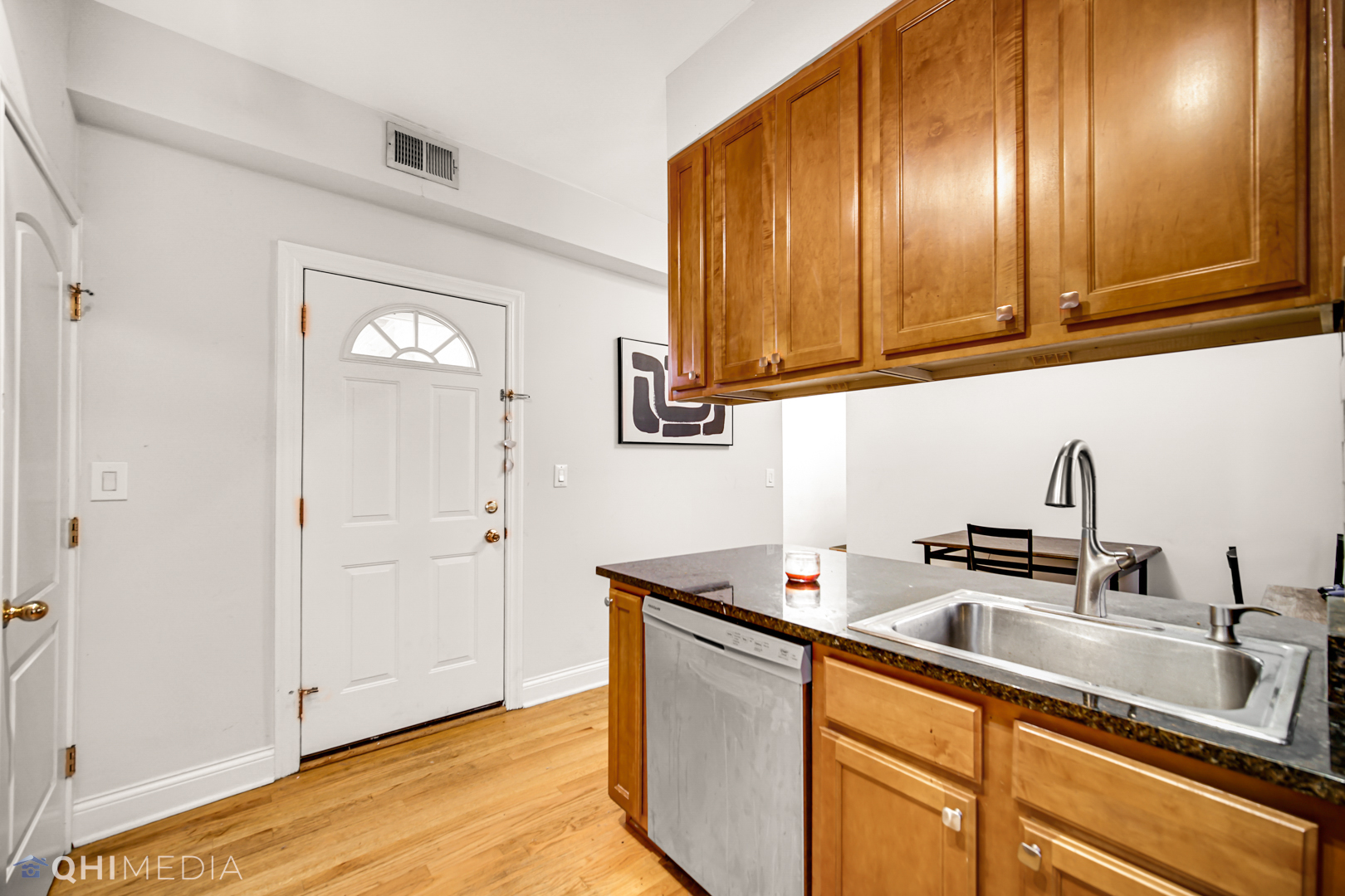 4014 North Spaulding Avenue, Unit 3 Chicago, IL 60618 - Photo 12 of 16 a kitchen with stainless steel appliances granite countertop white cabinets a sink and dishwasher