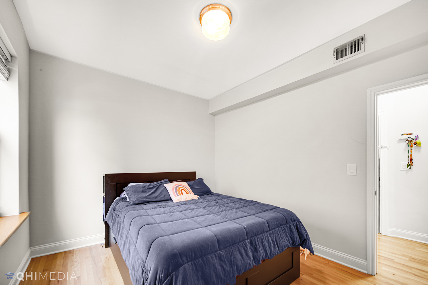 4014 North Spaulding Avenue, Unit 3 Chicago, IL 60618 - Photo 16 of 16 a bed sitting in a bedroom next to a window