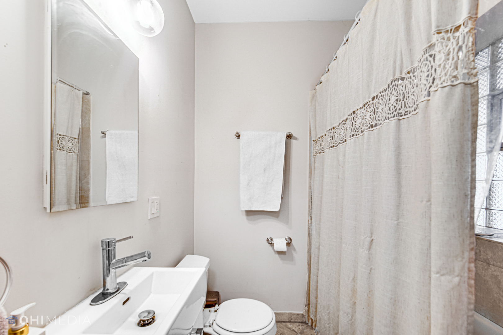 4014 North Spaulding Avenue, Unit 3 Chicago, IL 60618 - Photo 8 of 16 a bathroom with a sink and a mirror