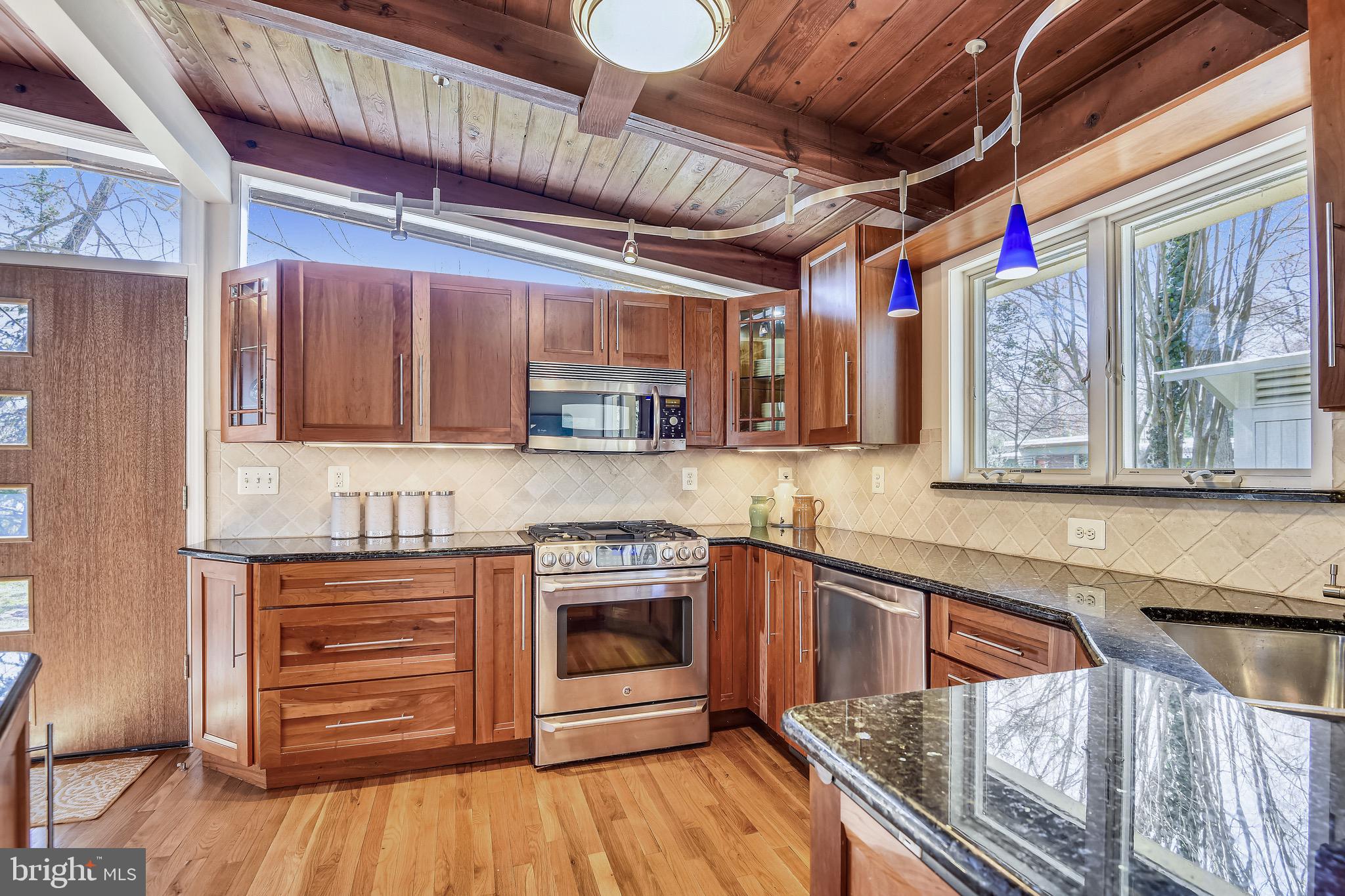 Cherry cabinets and a five-burner stove.