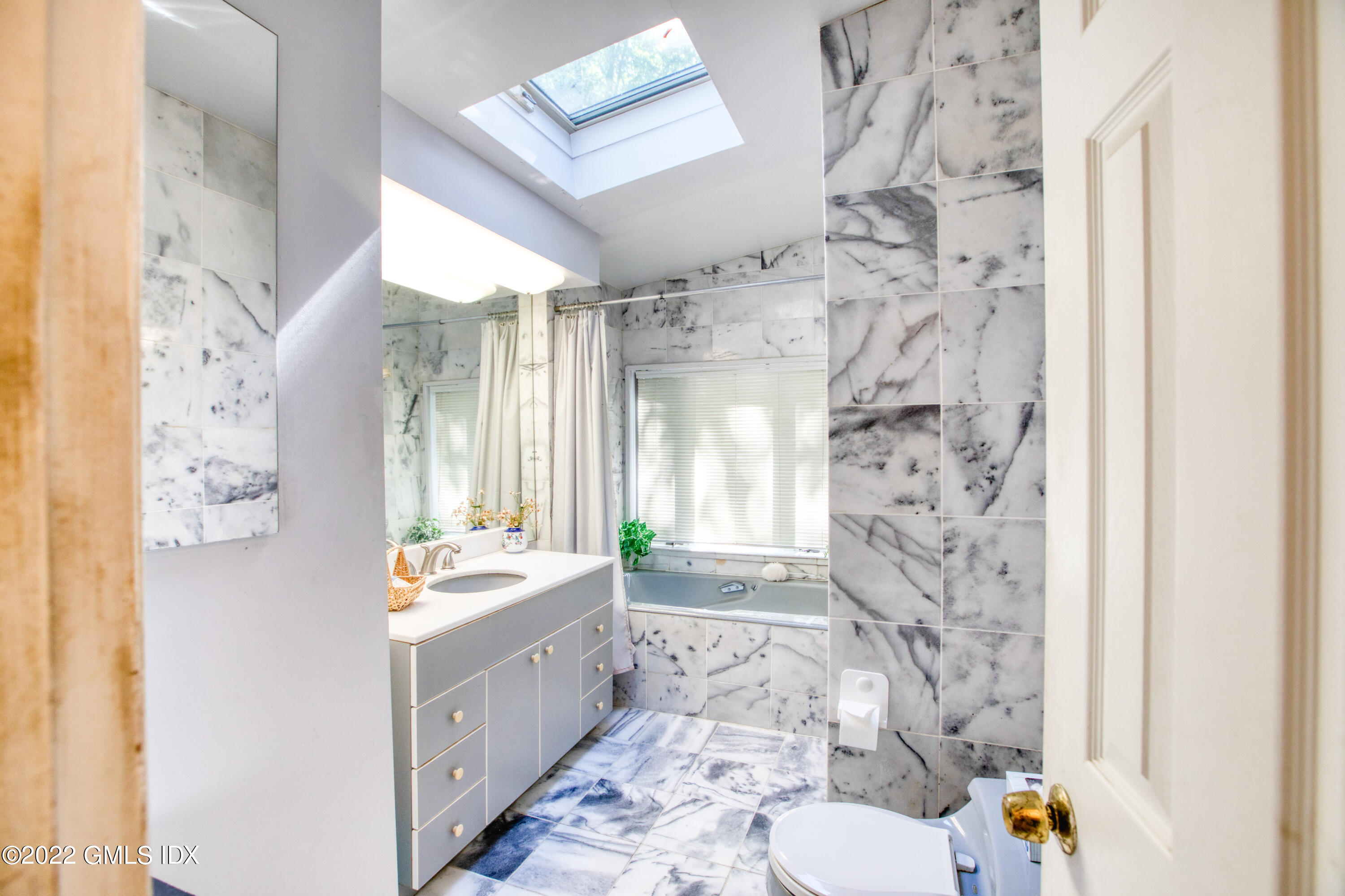 94 Florence Road Riverside, CT 06878 - Photo 12 of 25 a bathroom with a sink mirror toilet and shower