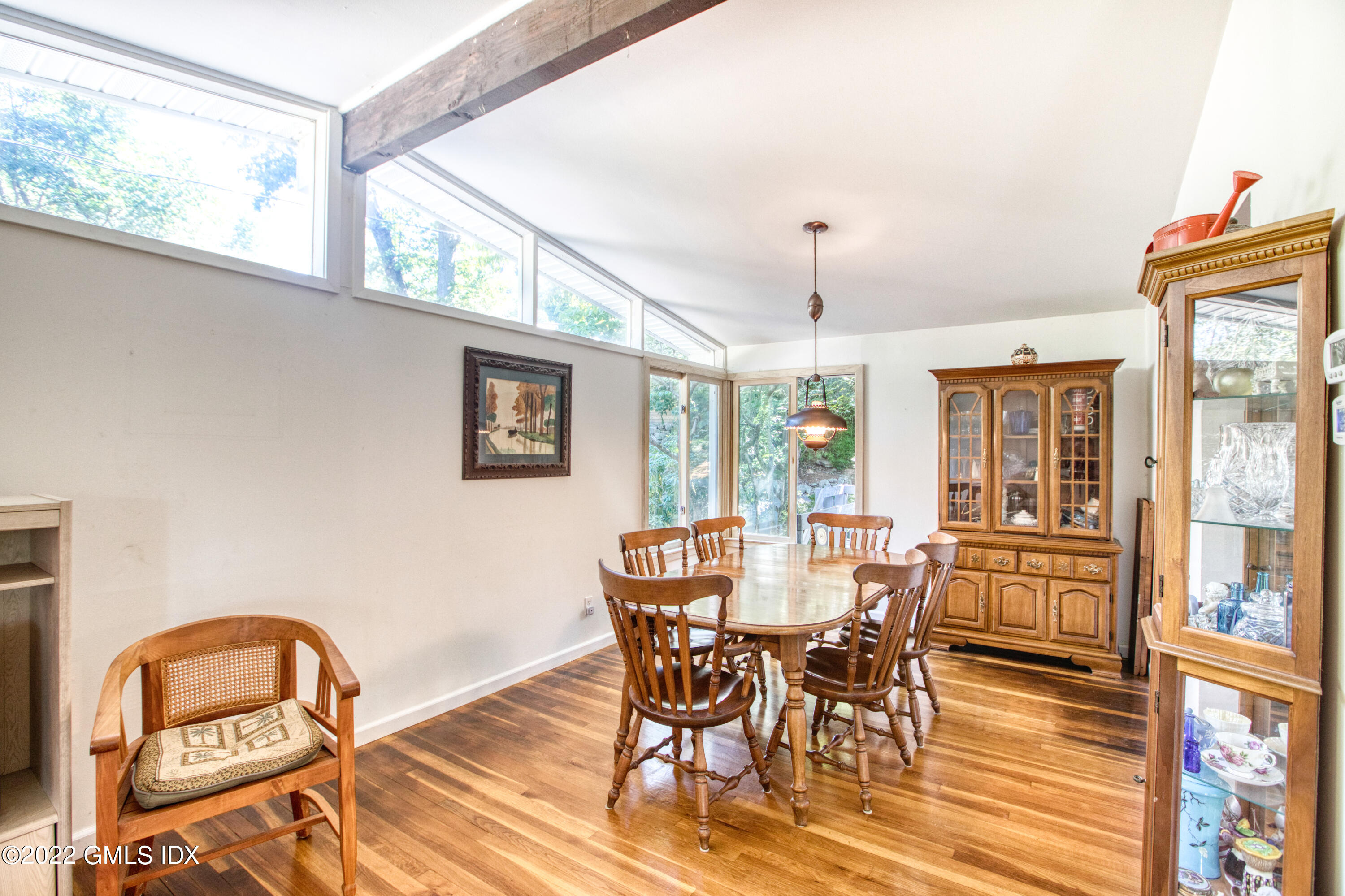 94 Florence Road Riverside, CT 06878 - Photo 6 of 25 a dining room with furniture a chandelier and wooden floor