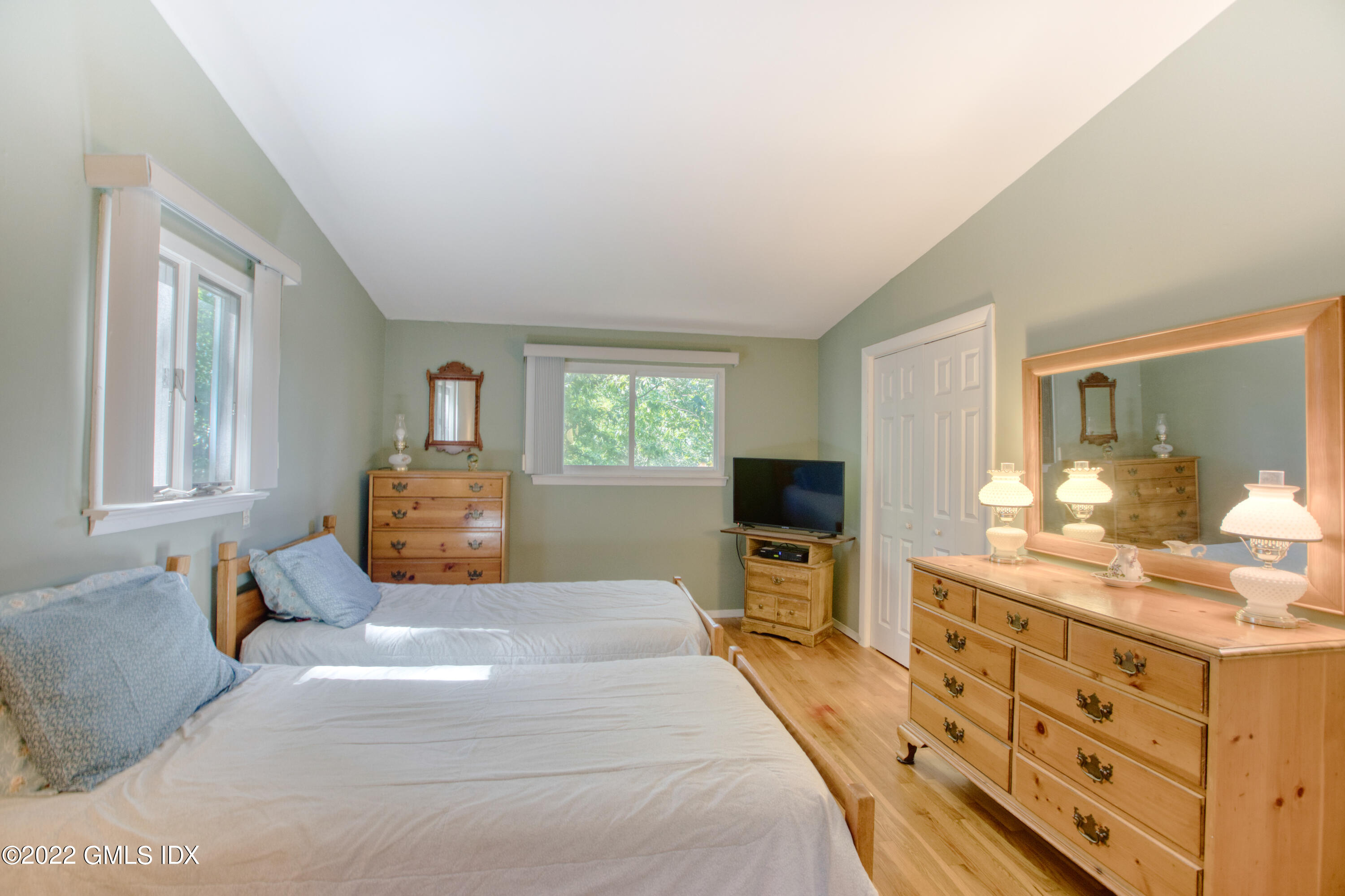94 Florence Road Riverside, CT 06878 - Photo 9 of 25 a bedroom with a bed and wooden floor