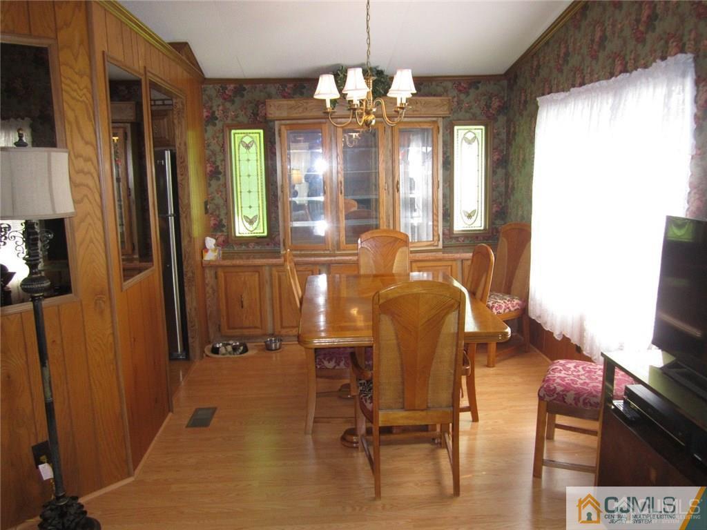25 Longfellow Road, Unit 1 North Brunswick, NJ 08902 - Photo 4 of 17 a view of a dining room with furniture and a chandelier