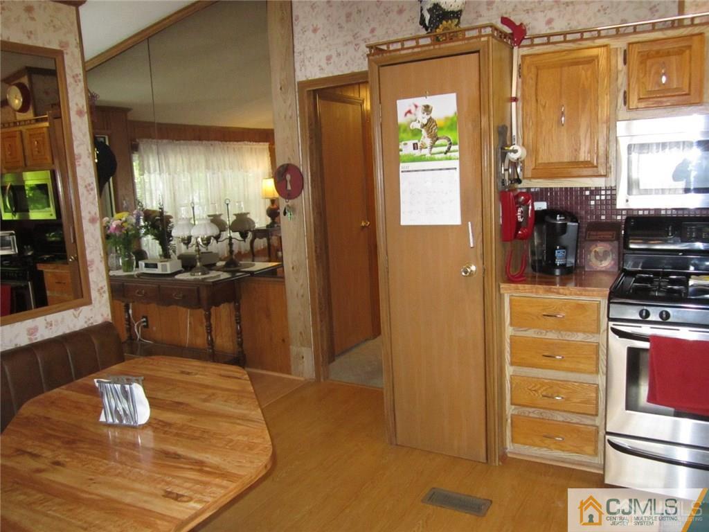 25 Longfellow Road, Unit 1 North Brunswick, NJ 08902 - Photo 5 of 17 a kitchen with a refrigerator and a stove
