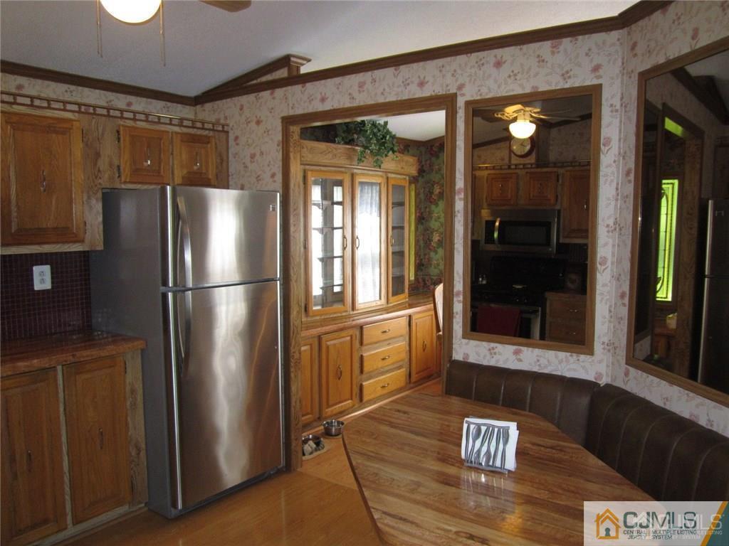 25 Longfellow Road, Unit 1 North Brunswick, NJ 08902 - Photo 6 of 17 a kitchen with stainless steel appliances granite countertop a refrigerator and a stove