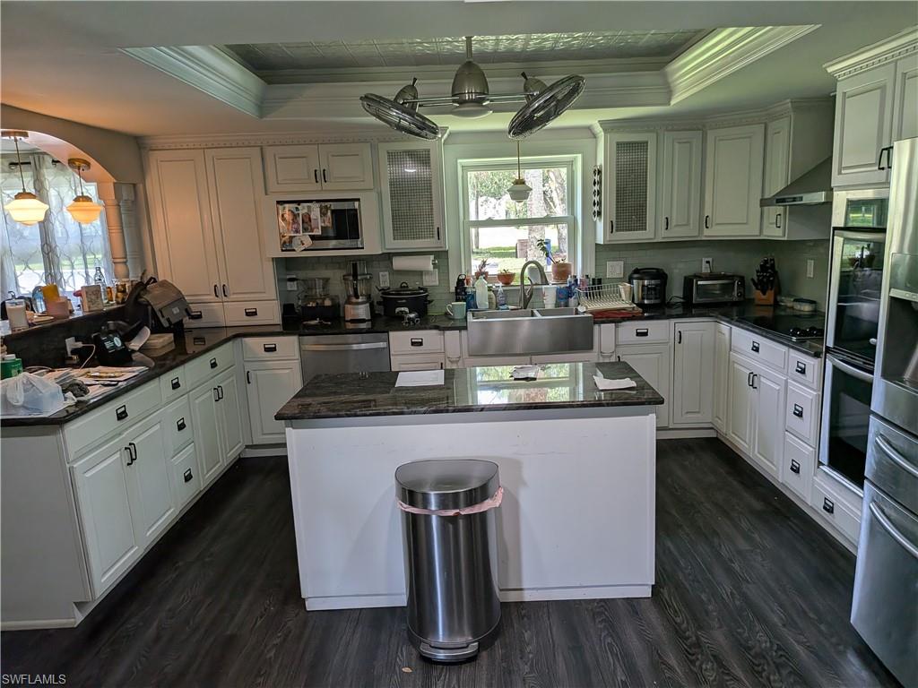 17191 Frank Road Alva, FL 33920 - Photo 13 of 27 a kitchen with stainless steel appliances granite countertop a sink stove and refrigerator