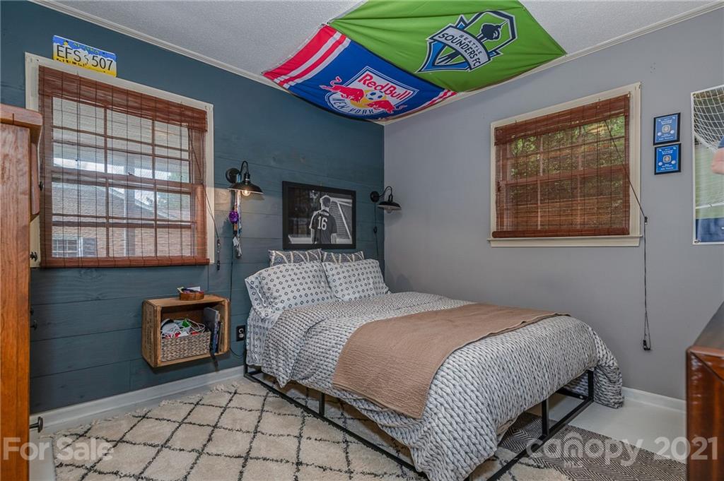 137 Anne Street Rutherfordton, NC 28139 - Photo 14 of 45 a bedroom with a bed and a painting on the wall