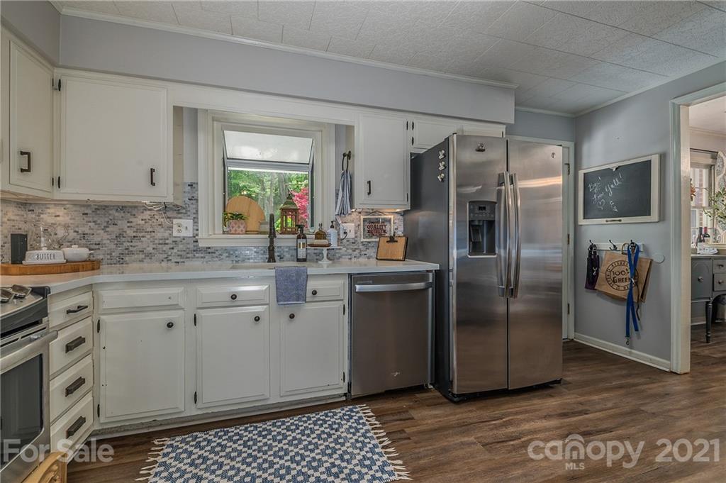 137 Anne Street Rutherfordton, NC 28139 - Photo 19 of 45 a kitchen with stainless steel appliances a refrigerator sink and cabinets