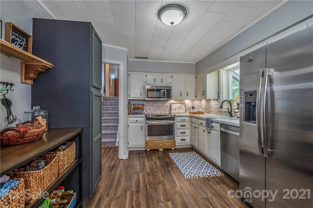 137 Anne Street Rutherfordton, NC 28139 - Photo 20 of 45 a kitchen with a refrigerator cabinets and wooden floor