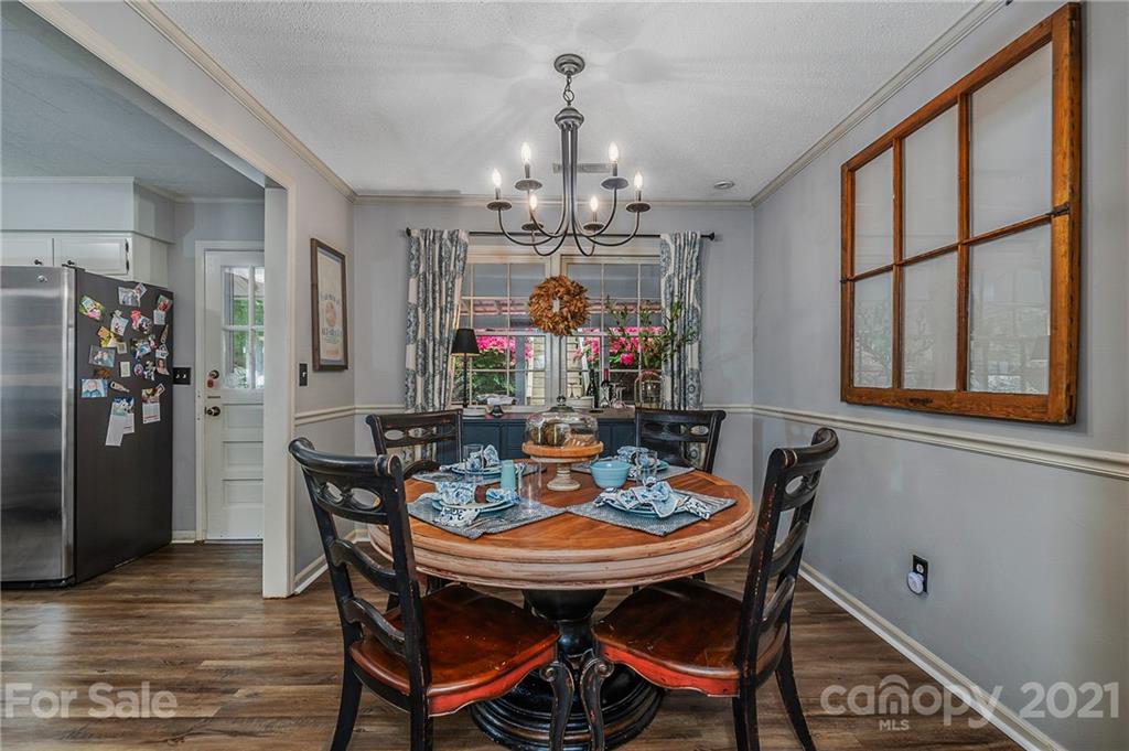 137 Anne Street Rutherfordton, NC 28139 - Photo 21 of 45 a view of a dining room with furniture a chandelier and wooden floor