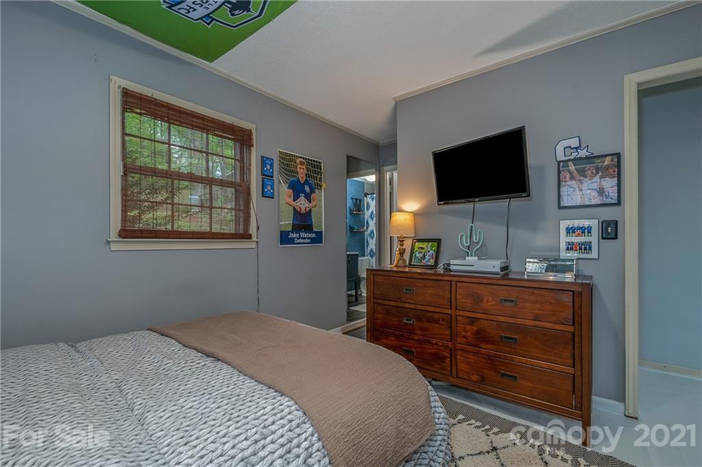 137 Anne Street Rutherfordton, NC 28139 - Photo 26 of 45 a bedroom with a bed and a flat screen tv