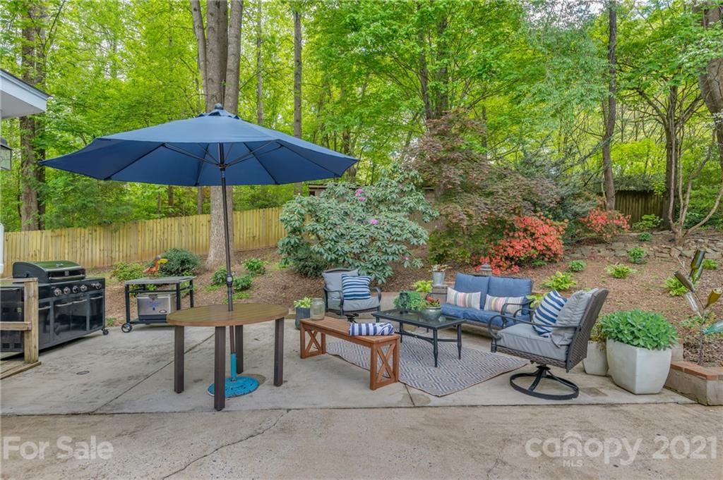 137 Anne Street Rutherfordton, NC 28139 - Photo 40 of 45 a view of a patio with chairs and table under an umbrella