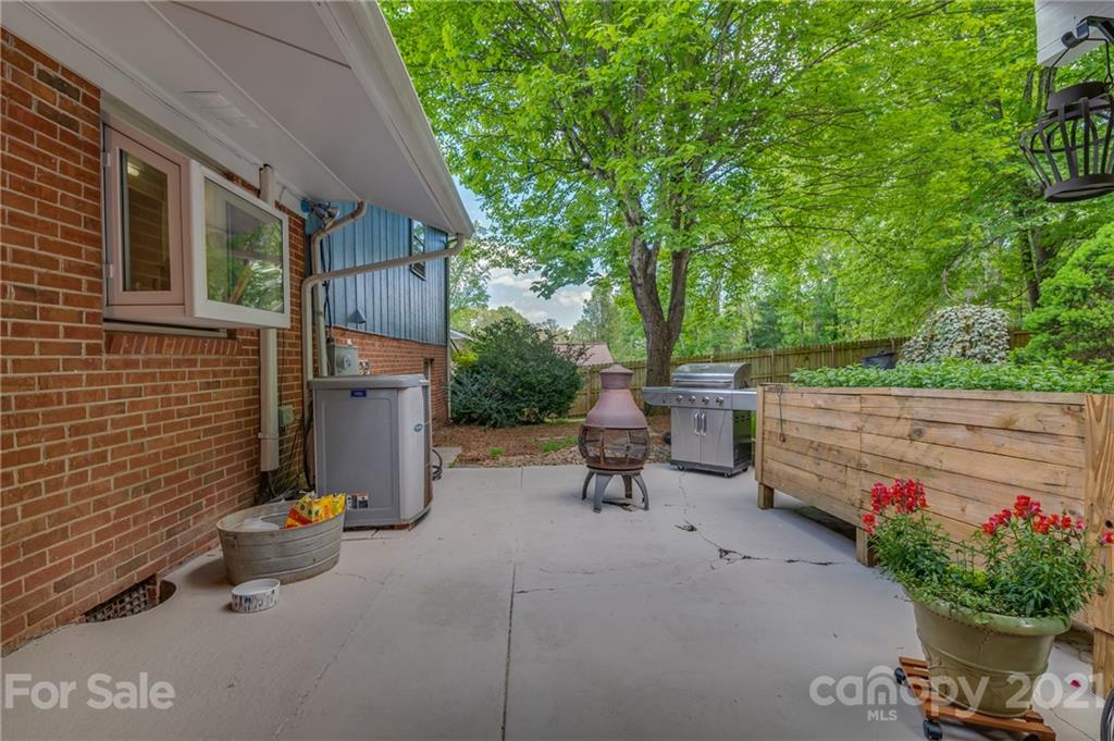 137 Anne Street Rutherfordton, NC 28139 - Photo 41 of 45 a backyard of a house with table and chairs potted plants