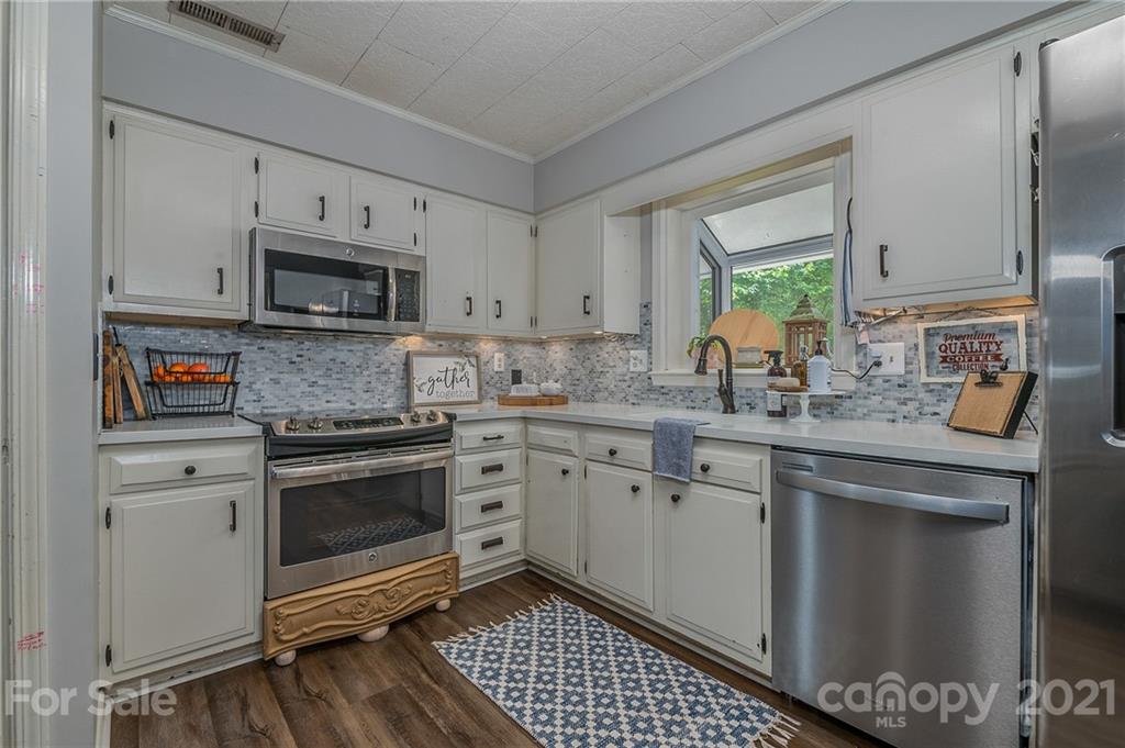 137 Anne Street Rutherfordton, NC 28139 - Photo 6 of 45 a kitchen with granite countertop a sink stove and microwave