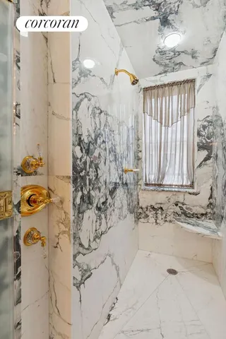 a bathroom with shower and window