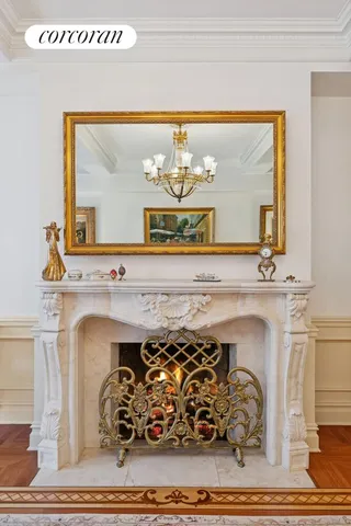 a living room with fireplace furniture and a chandelier