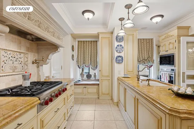 a dining room with furniture a chandelier and wooden floor