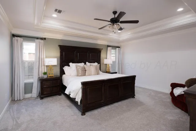 a bed room with a bed and a ceiling fan