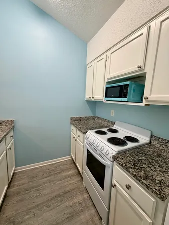 a stove top oven sitting inside of a kitchen