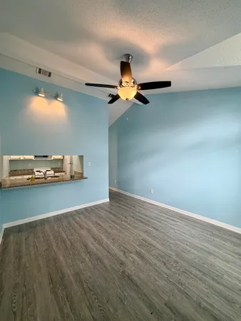 a view of a room with wooden floor
