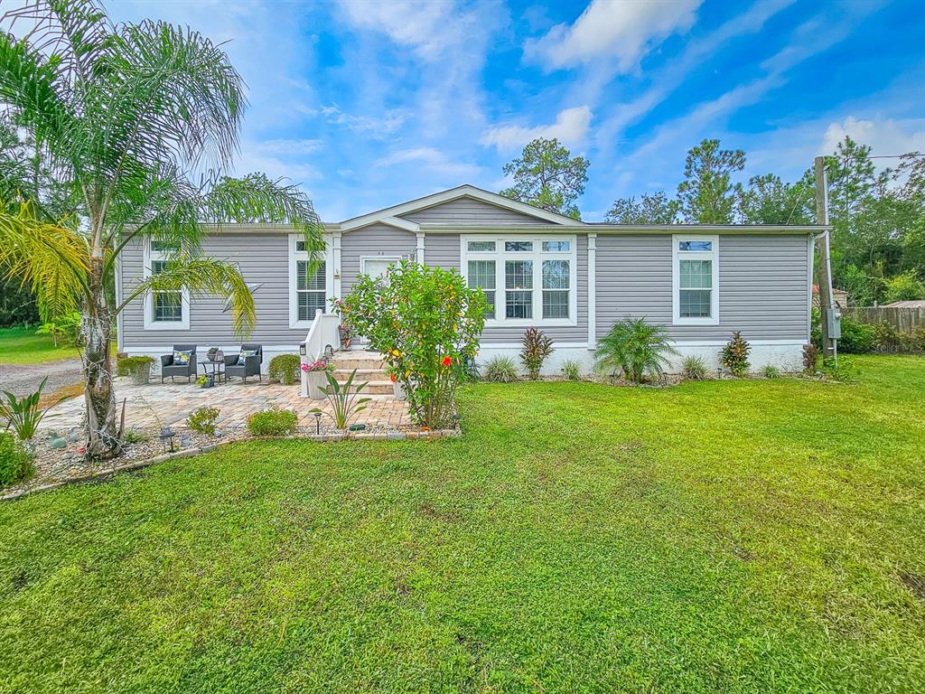 5487 Palm Avenue Bunnell, FL 32110 - Photo 1 of 1 a front view of house with yard and green space