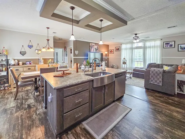 a room with kitchen island granite countertop lots of counter top space