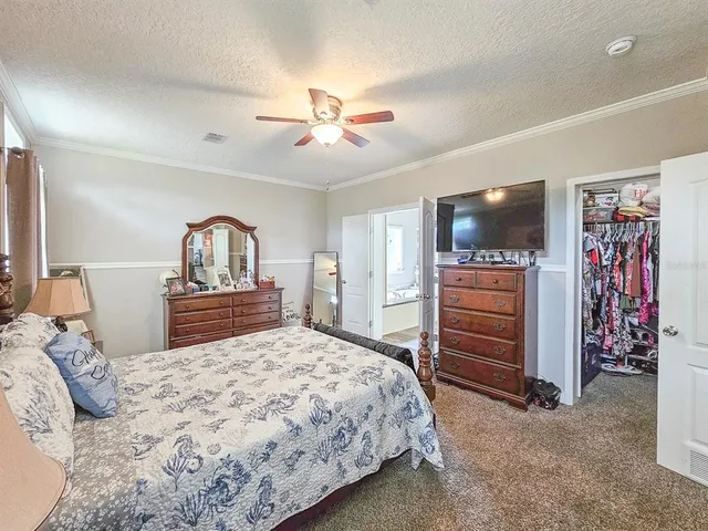 a bedroom with a large bed and a flat screen tv