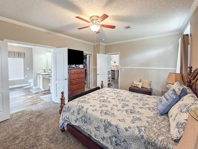 a bedroom with a bed and a television