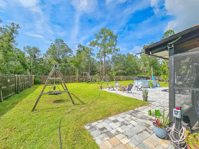 a view of a house with backyard and a slide