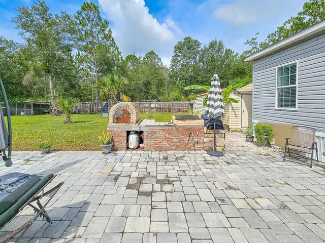 front view of a house with a yard table and chairs