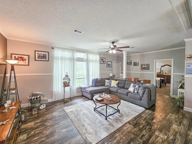 a living room with furniture and a chandelier