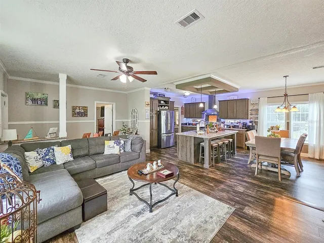 a living room with lots of furniture and kitchen view