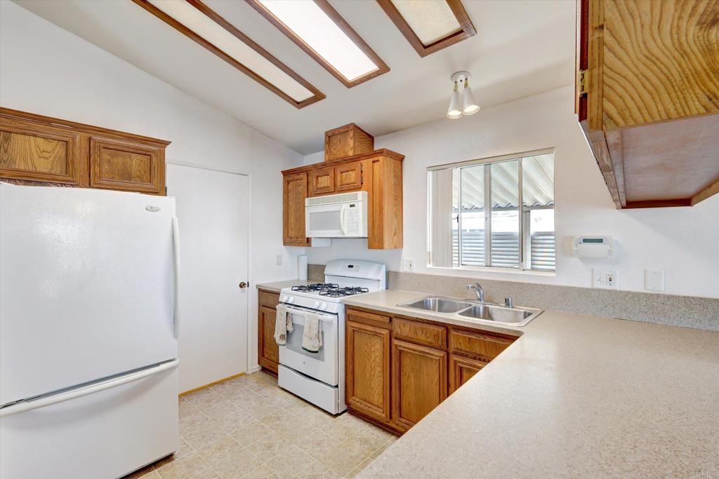 205 Mockingbird Lane Oceanside, CA 92057 - Photo 12 of 28 a view of a kitchen with a sink a washer and dryer