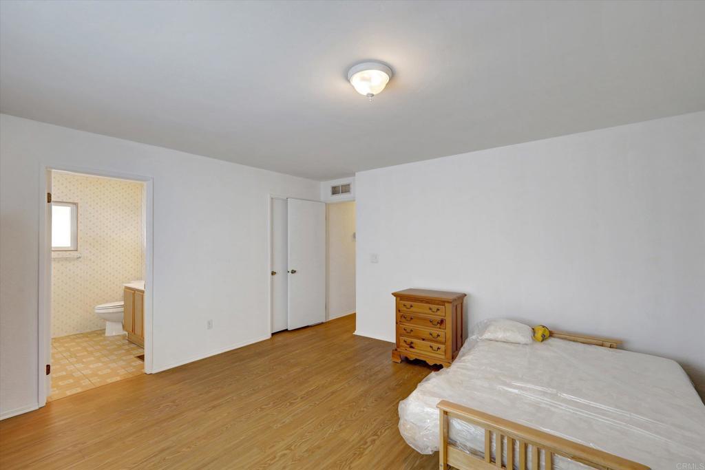 205 Mockingbird Lane Oceanside, CA 92057 - Photo 16 of 28 a bedroom with furniture and wooden floor