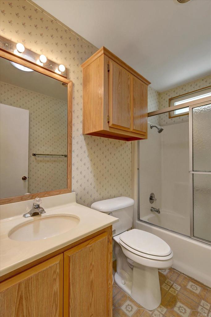 205 Mockingbird Lane Oceanside, CA 92057 - Photo 27 of 28 a bathroom with a sink a toilet and shower