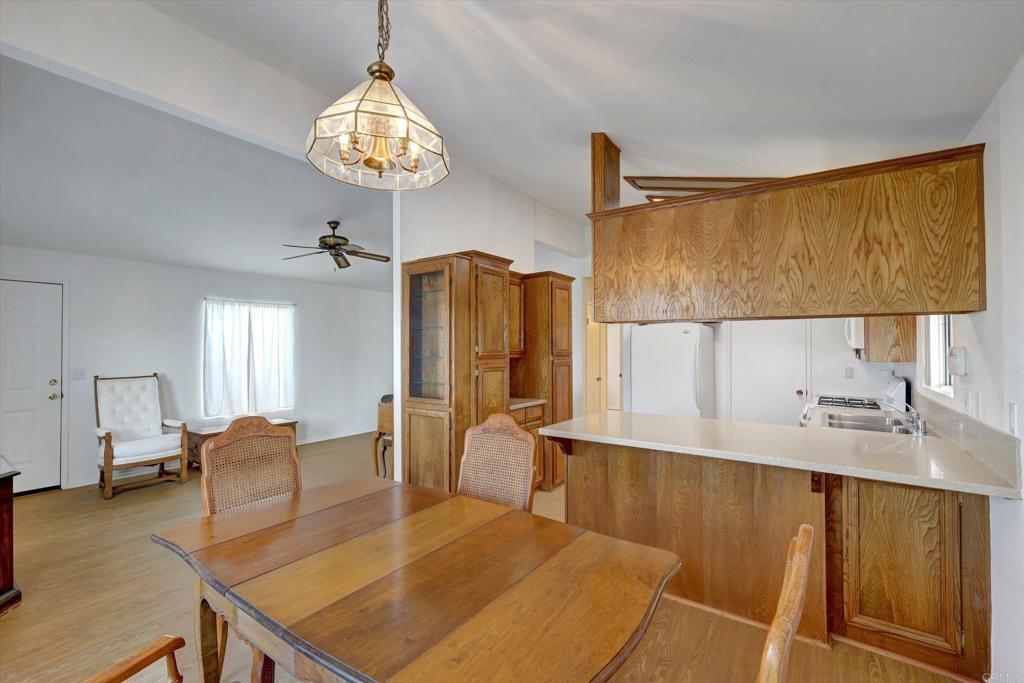 205 Mockingbird Lane Oceanside, CA 92057 - Photo 9 of 28 a kitchen with stainless steel appliances granite countertop a sink dishwasher and a refrigerator with wooden floor