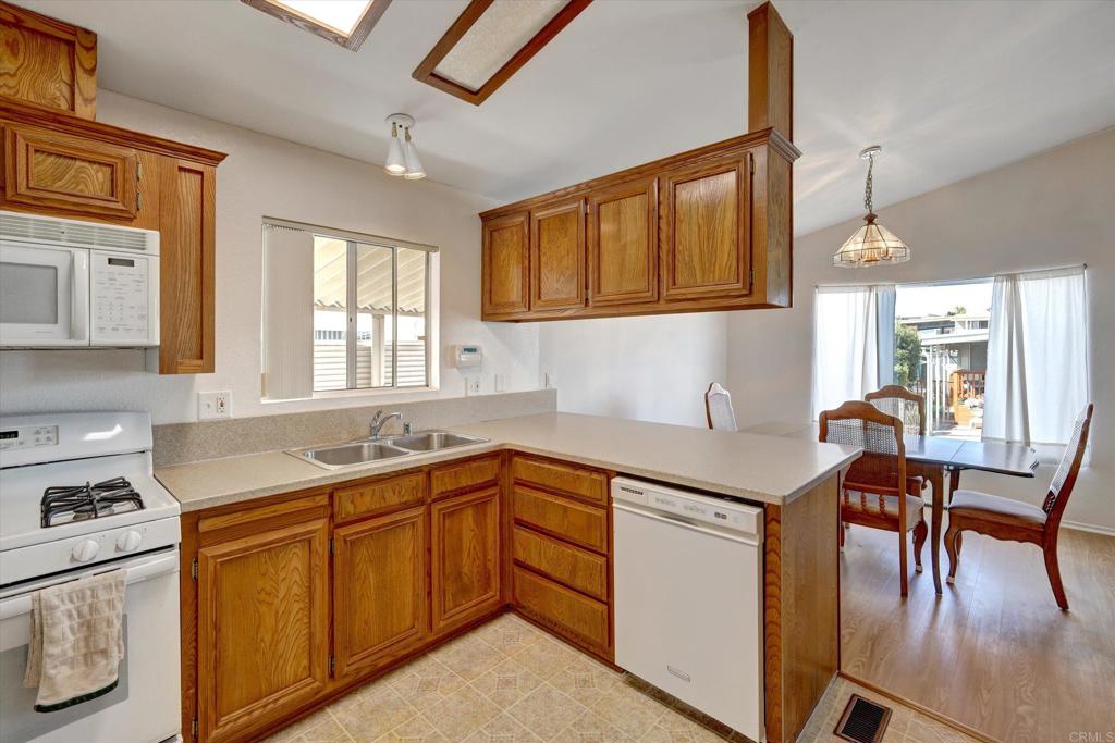 205 Mockingbird Lane Oceanside, CA 92057 - Photo 10 of 28 a kitchen with a sink stove and cabinets
