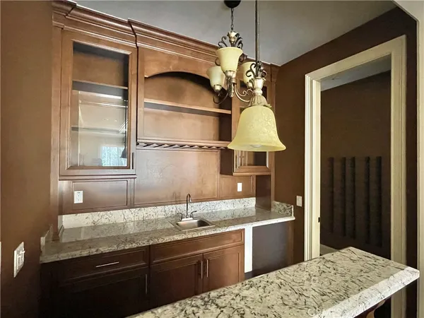 a kitchen with a sink and chandelier