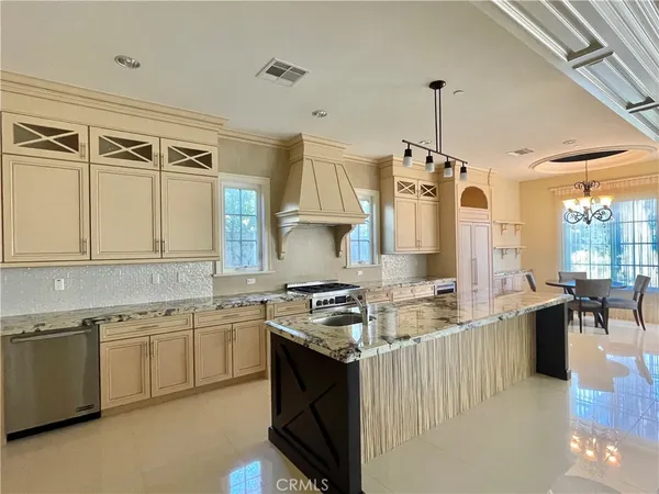 a kitchen with a stove a sink and a refrigerator