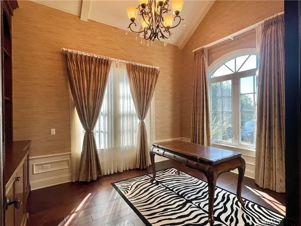 a living room with a bed wooden floor and a window