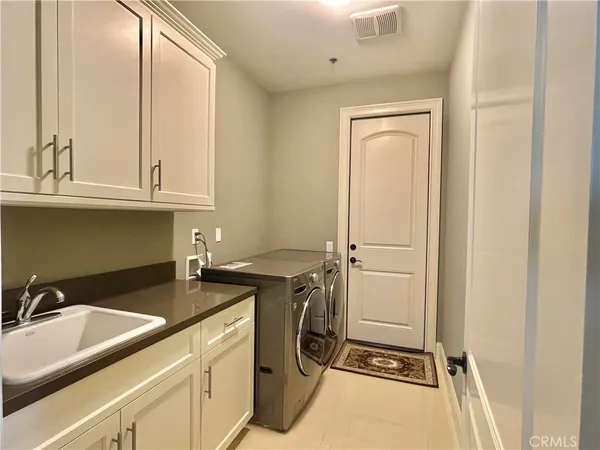 a utility room with faucet washer and dryer