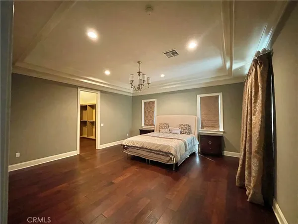 a bedroom with a bed and a chandelier
