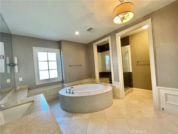 a spacious bathroom with a tub and shower