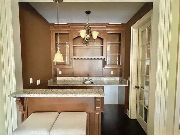a bathroom with a granite countertop sink a mirror and a shower