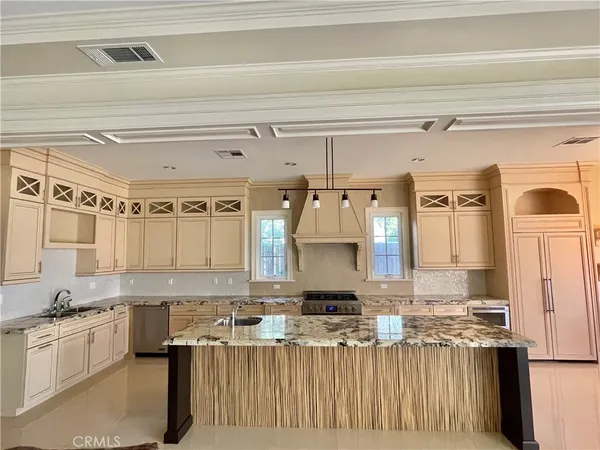 a kitchen with stainless steel appliances granite countertop a sink and cabinets
